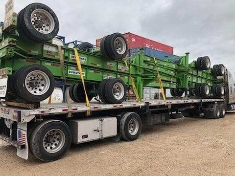 Oversize machinery loaded on a step deck trailer